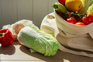 Photo of Fresh Chinese cabbage and other products on wooden table indoors