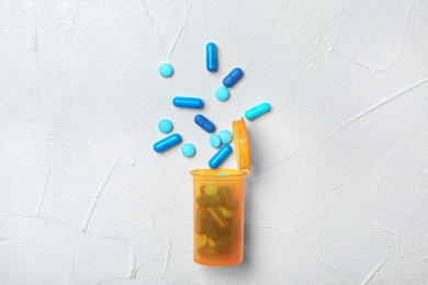 Photo of Bottle with pills on gray background
