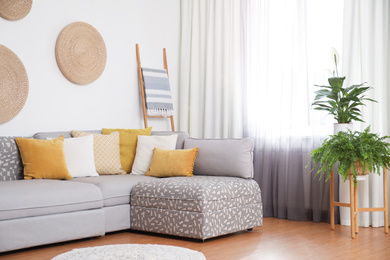 Photo of Window with stylish curtains in living room interior