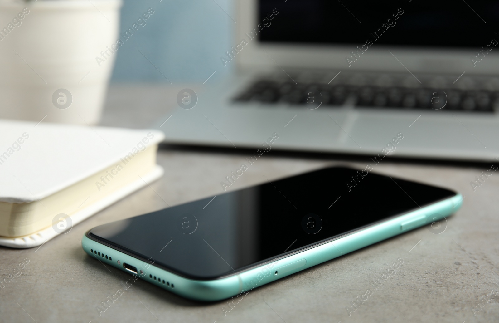 Photo of MYKOLAIV, UKRAINE - JULY 9, 2020: New modern Iphone 11 on light grey table, closeup