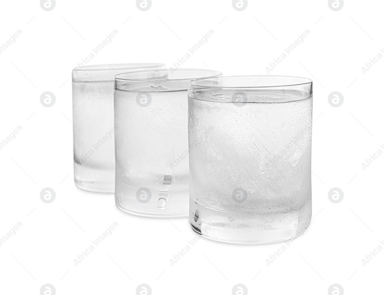 Photo of Vodka in shot glasses on white background