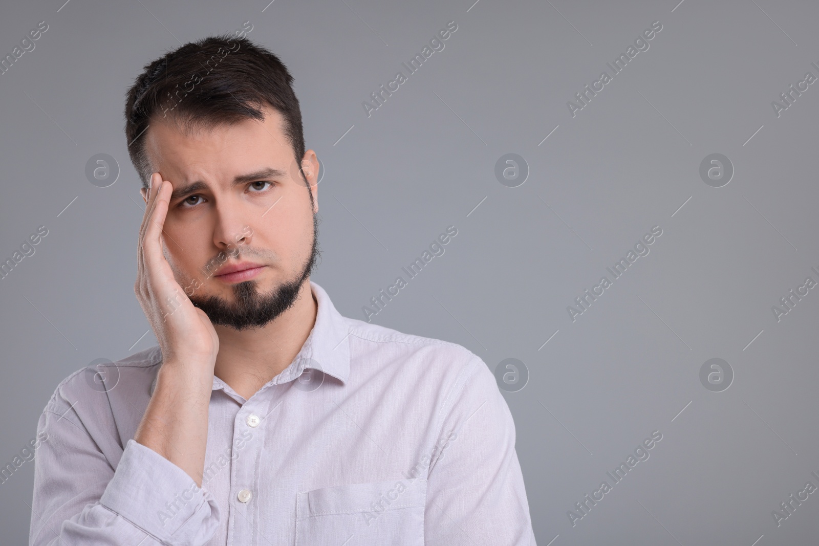 Photo of Portrait of sad man on grey background, space for text