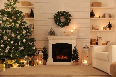 Photo of Stylish living room interior with decorated Christmas tree and comfortable sofa