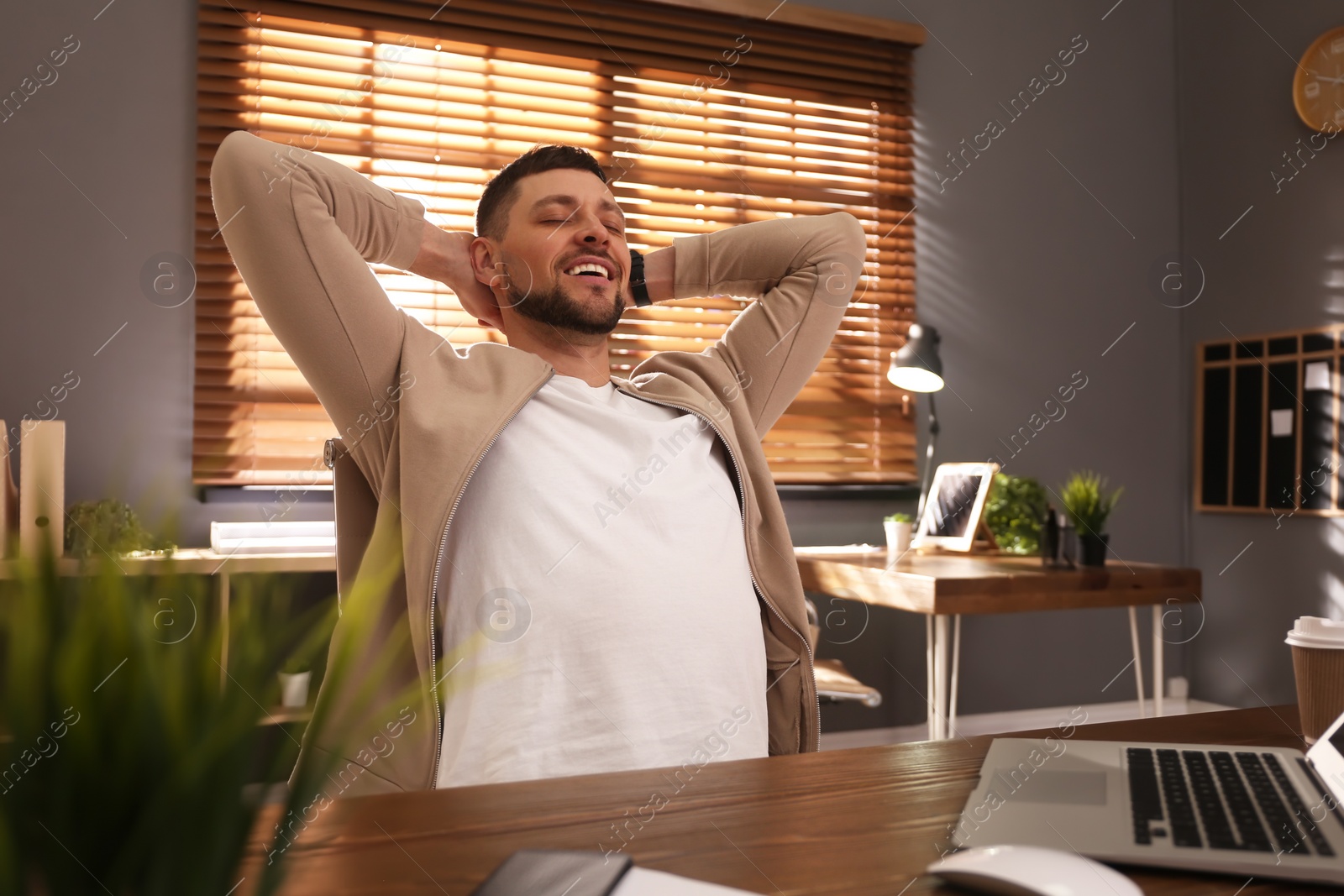 Photo of Freelancer resting from work at table indoors