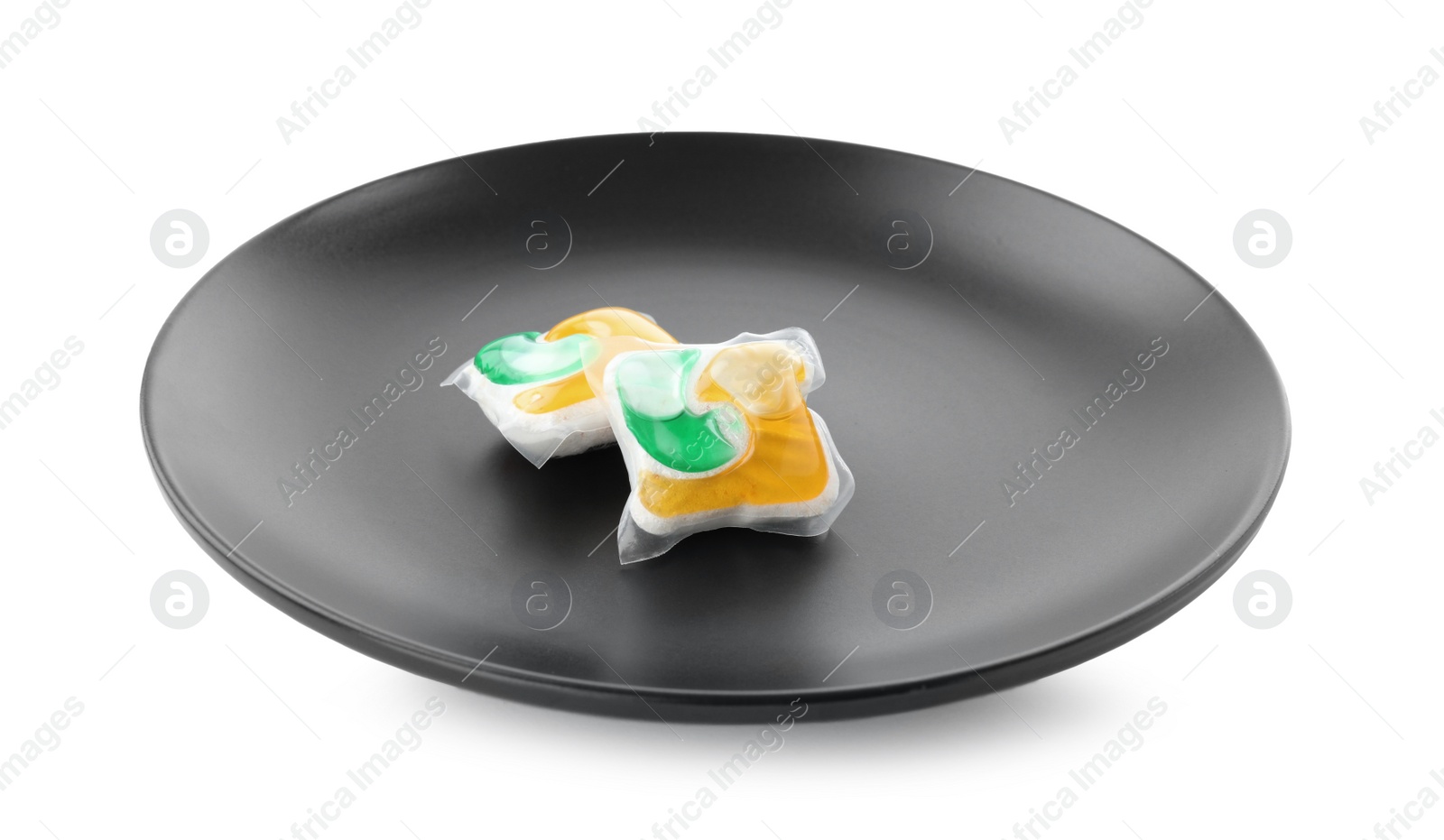 Photo of Black plate with dishwasher detergent pods on white background