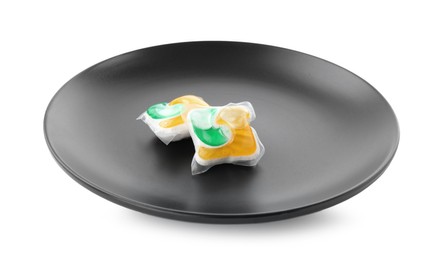 Black plate with dishwasher detergent pods on white background