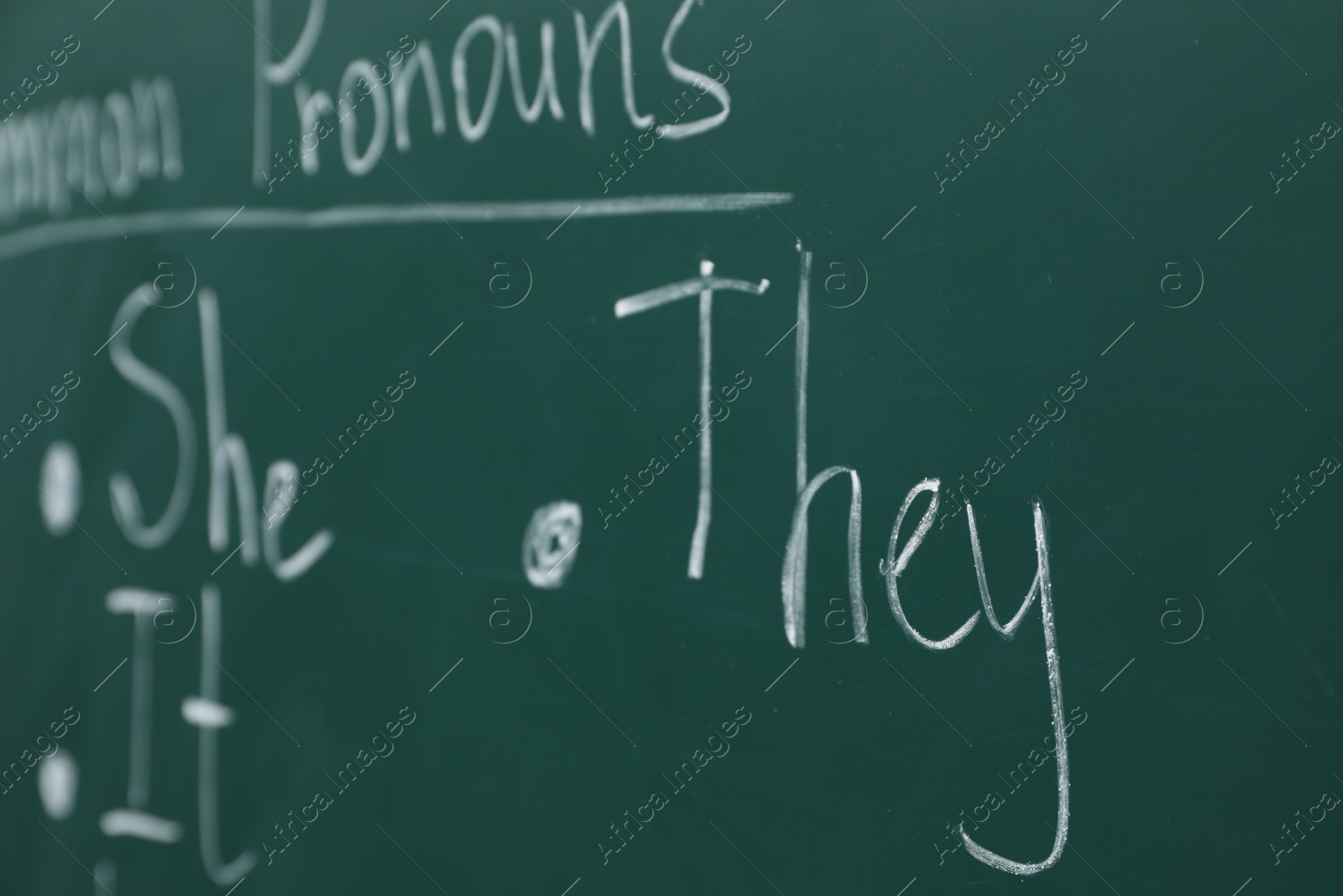 Photo of English grammar rules written with chalk on green board, closeup