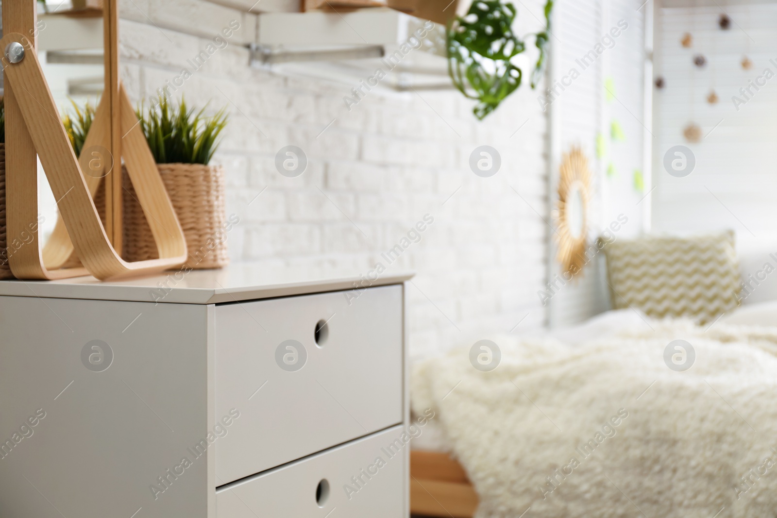 Photo of Stylish chest of drawers in bedroom interior