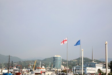 Photo of BATUMI, GEORGIA - MAY 31, 2022: Picturesque view of city with seaport on sunny day