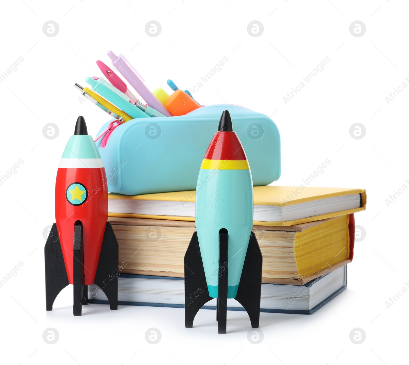 Photo of Bright toy rockets and school supplies on white background