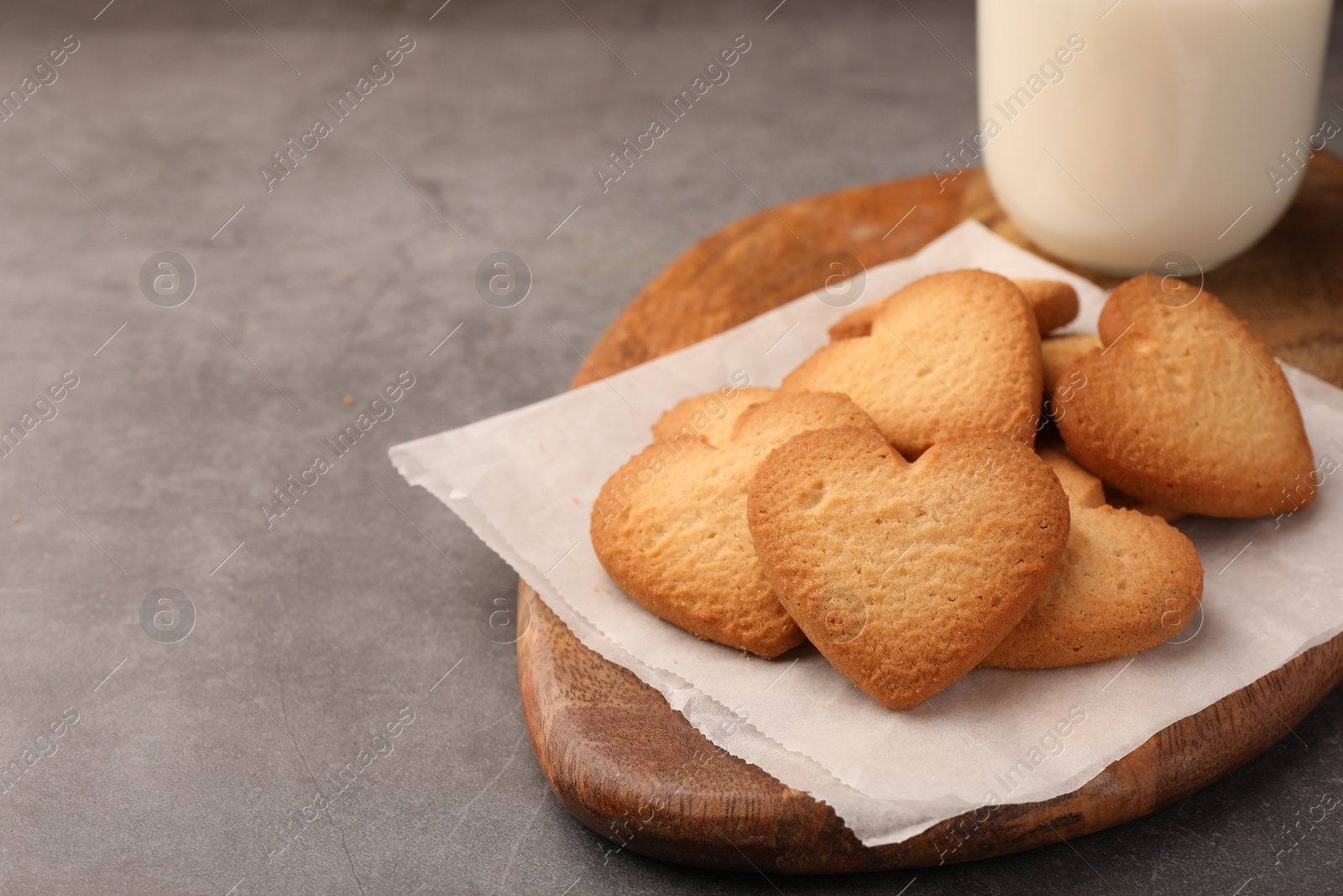 Photo of Heart shaped Danish butter cookies on grey table, closeup. Space for text