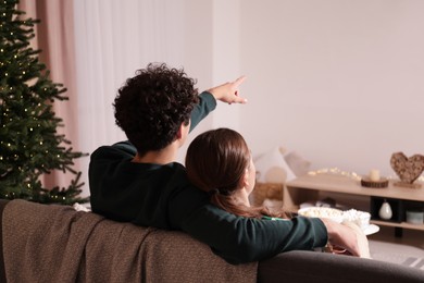 Photo of Couple watching romantic movie via video projector at home