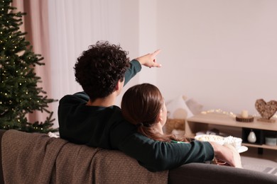 Couple watching romantic movie via video projector at home