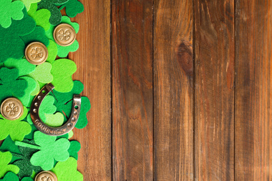Flat lay composition with horseshoe on wooden background, space for text. St. Patrick's Day celebration