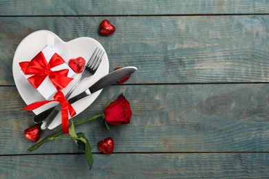 Photo of Beautiful table setting on wooden background, flat lay with space for text. Valentine's Day dinner