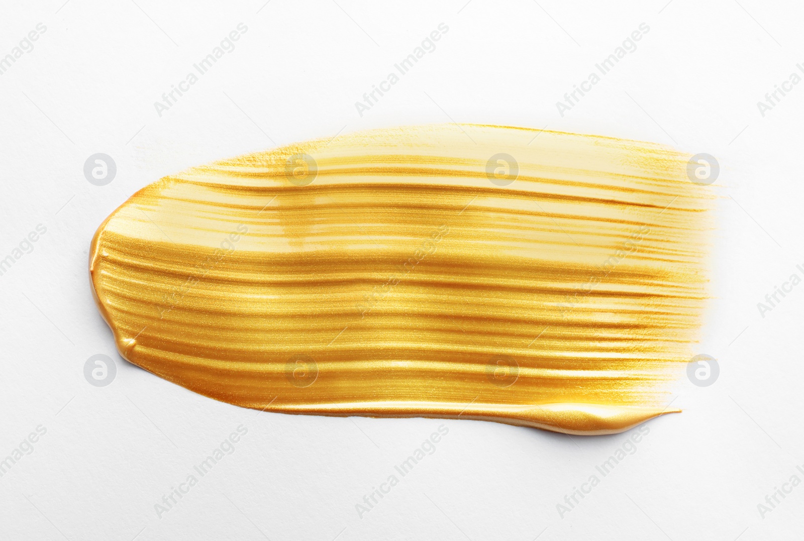 Photo of Stroke of gold paint isolated on white, top view