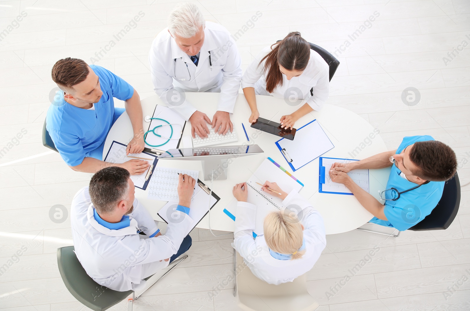 Photo of Group of doctors attending meeting in clinic. Cardiology conference