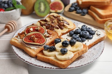 Photo of Different sweet delicious toasts on plate, closeup