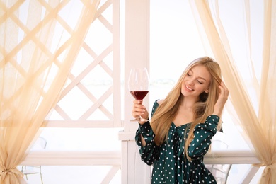 Photo of Beautiful woman with glass of wine on restaurant terrace