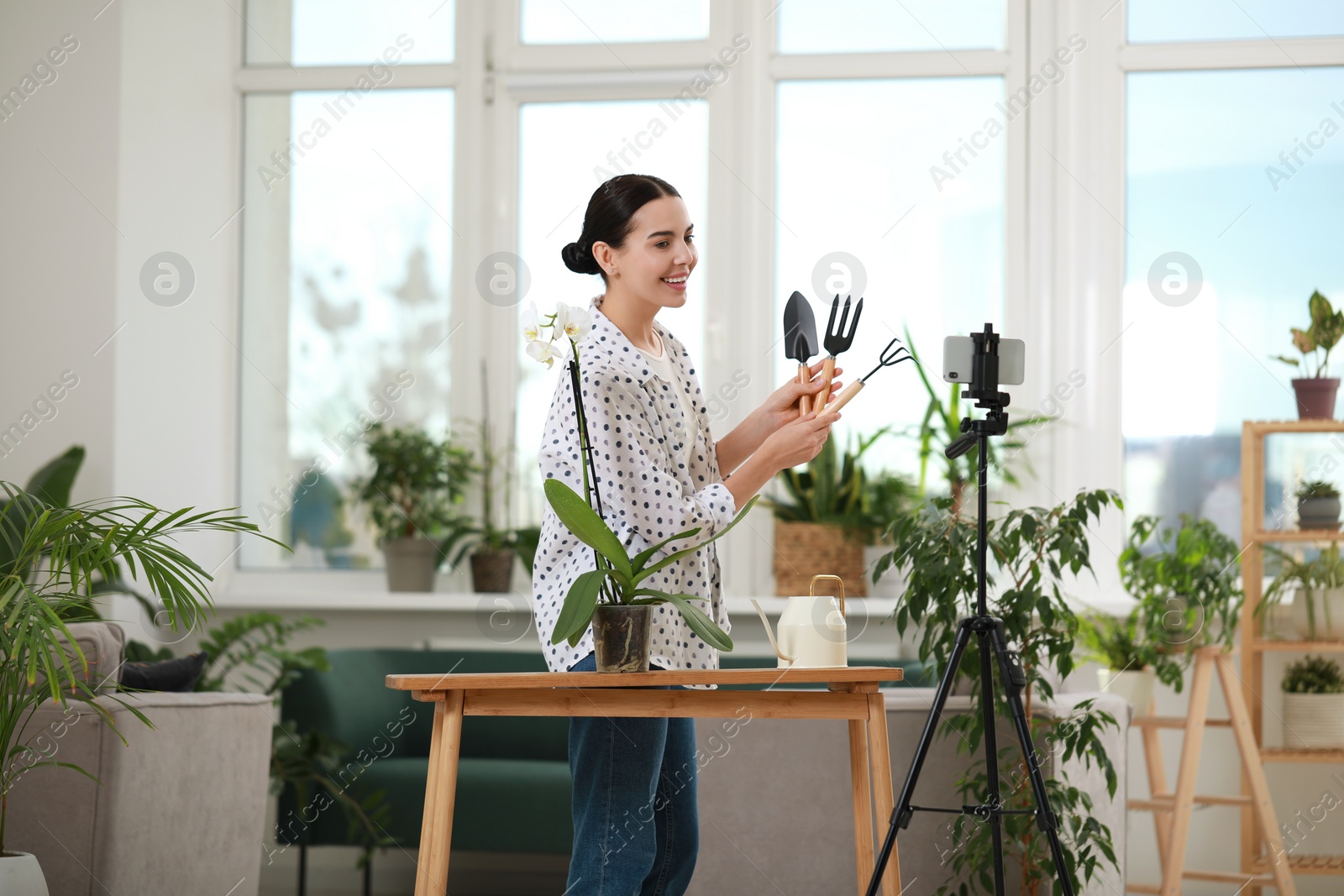 Photo of Teacher conducting online gardening course at home. Time for hobby