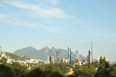 Picturesque view of mountains and city with skyscrapers