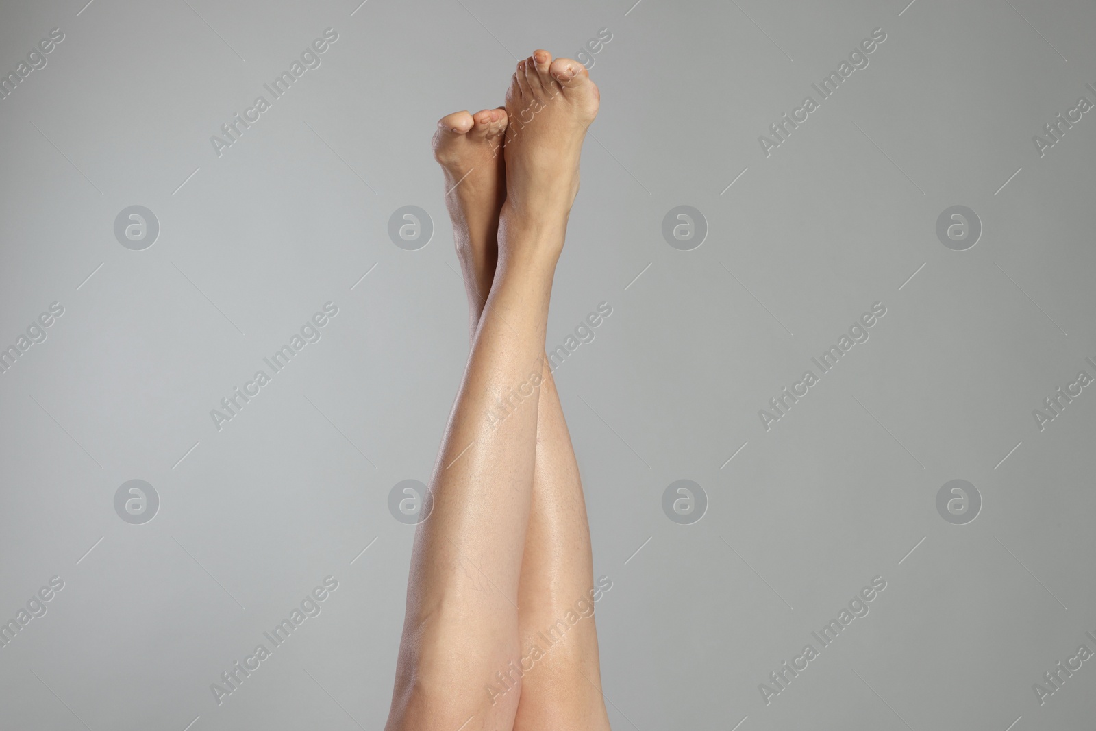 Photo of Closeup view of woman with varicose veins on light grey background