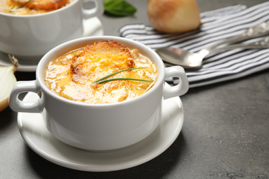 Photo of Tasty homemade french onion soup served on grey table
