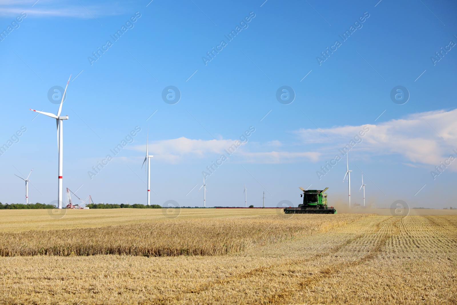 Photo of Modern combine harvester working in agricultural field