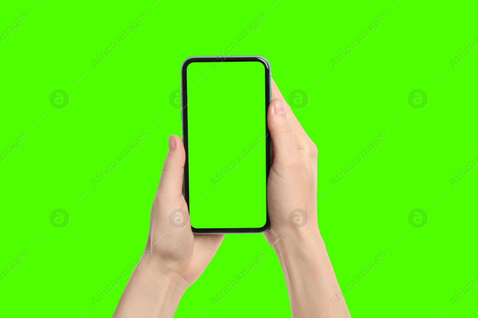 Image of Young woman holding smartphone with green screen on color background, closeup. Mockup for design