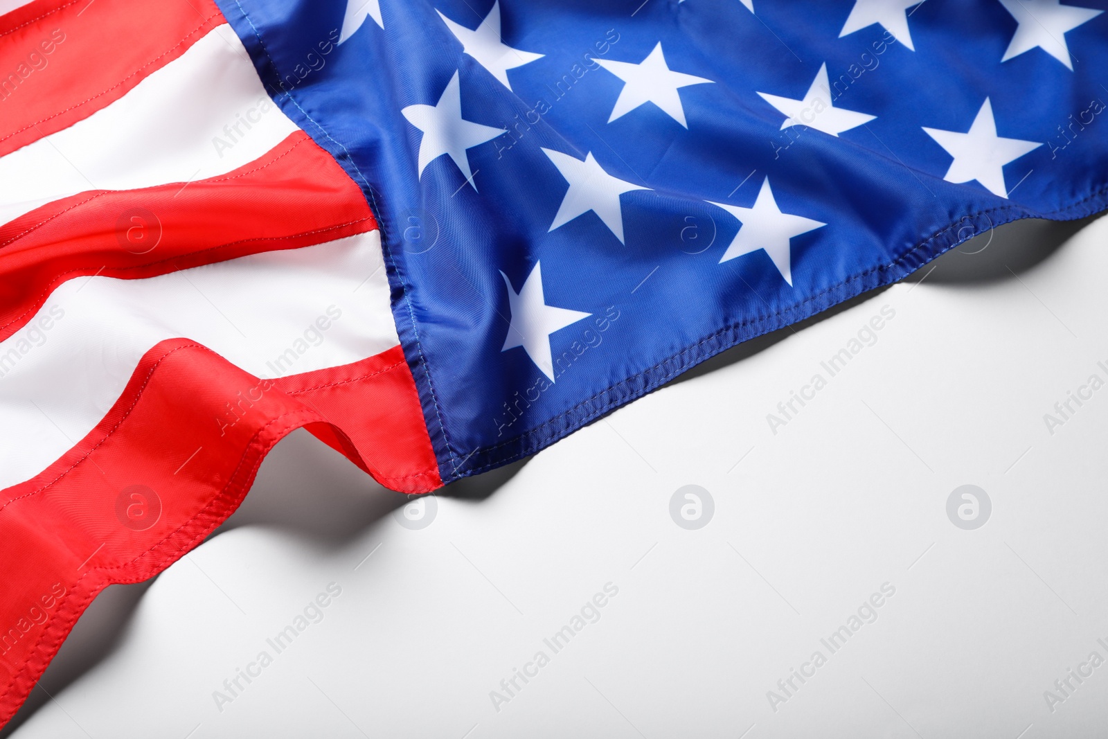 Photo of American flag on white background, closeup view