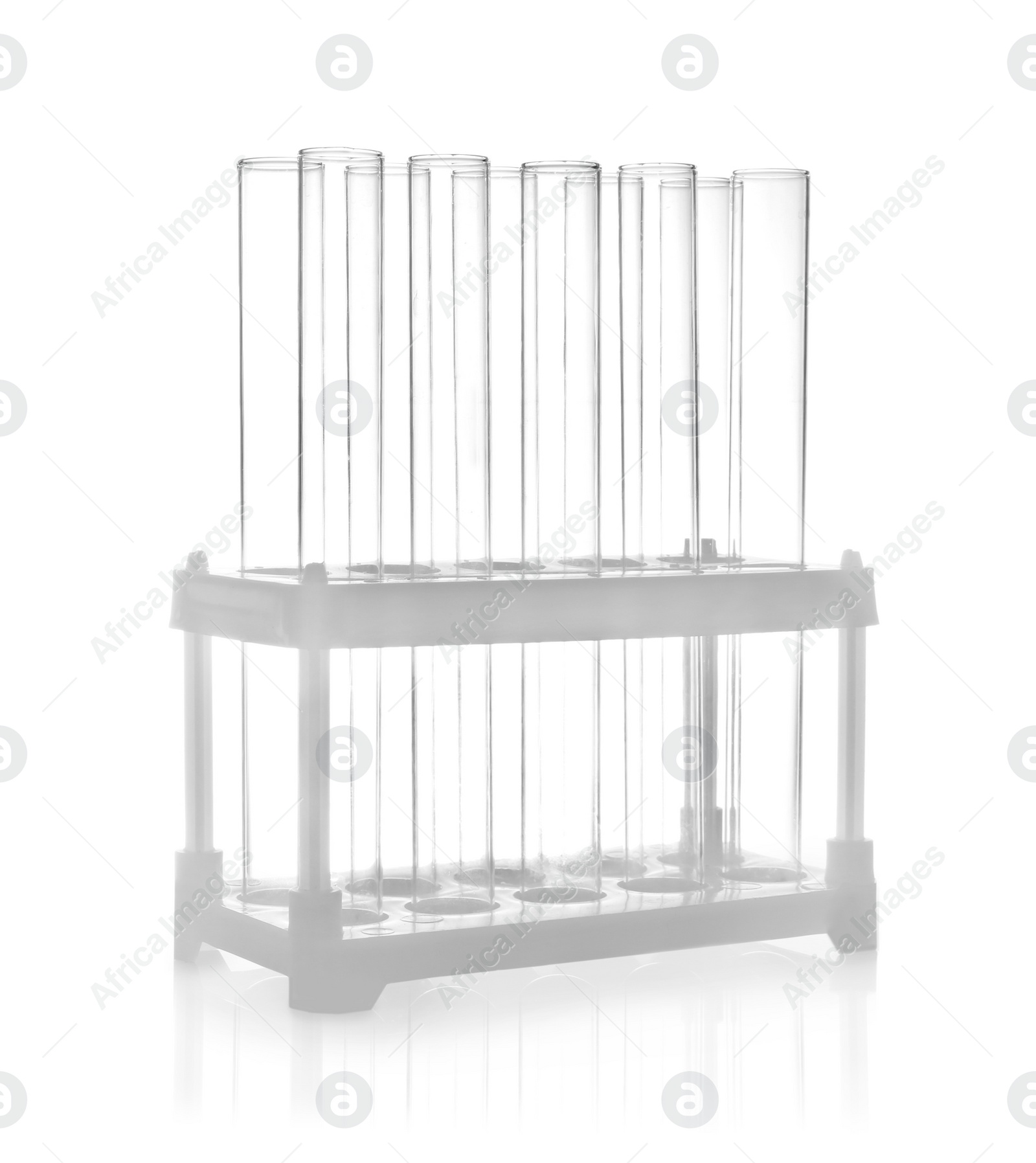 Photo of Holder with empty test tubes on white background. Laboratory glassware