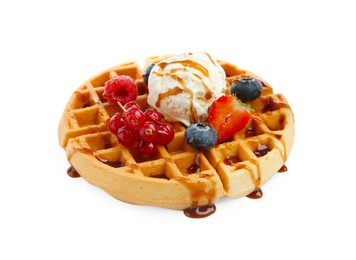 Tasty Belgian waffle with ice cream, berries and caramel syrup on white background