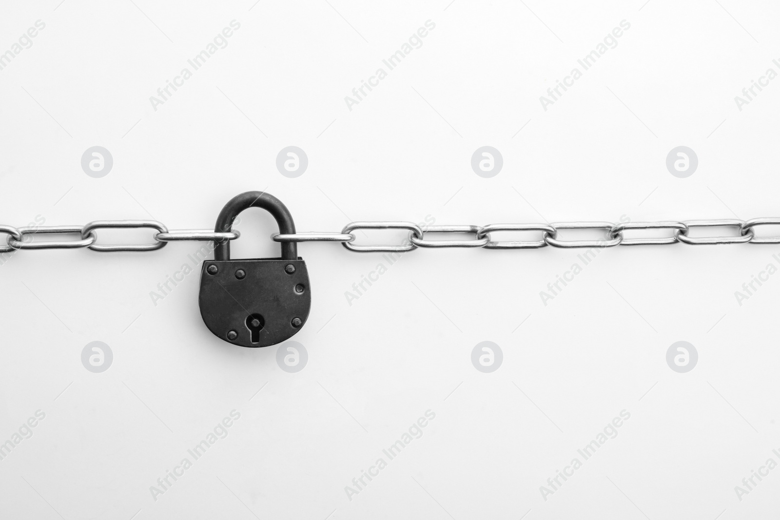 Photo of Steel padlock and chain isolated on white, top view. Safety concept