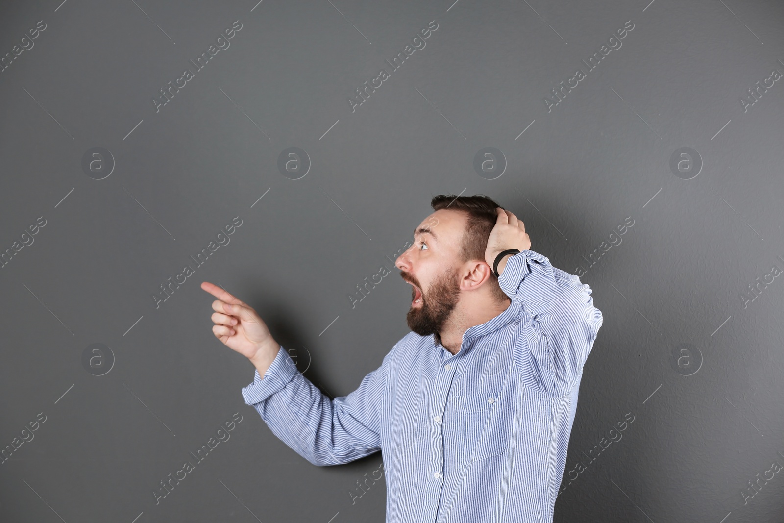 Photo of Portrait of handsome bearded man on color background