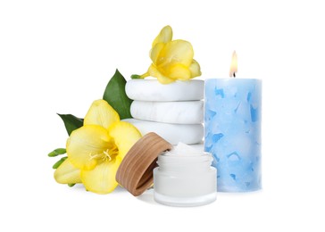 Image of Beautiful composition with jar of body cream, flowers, stones and burning candle on white background. Spa therapy