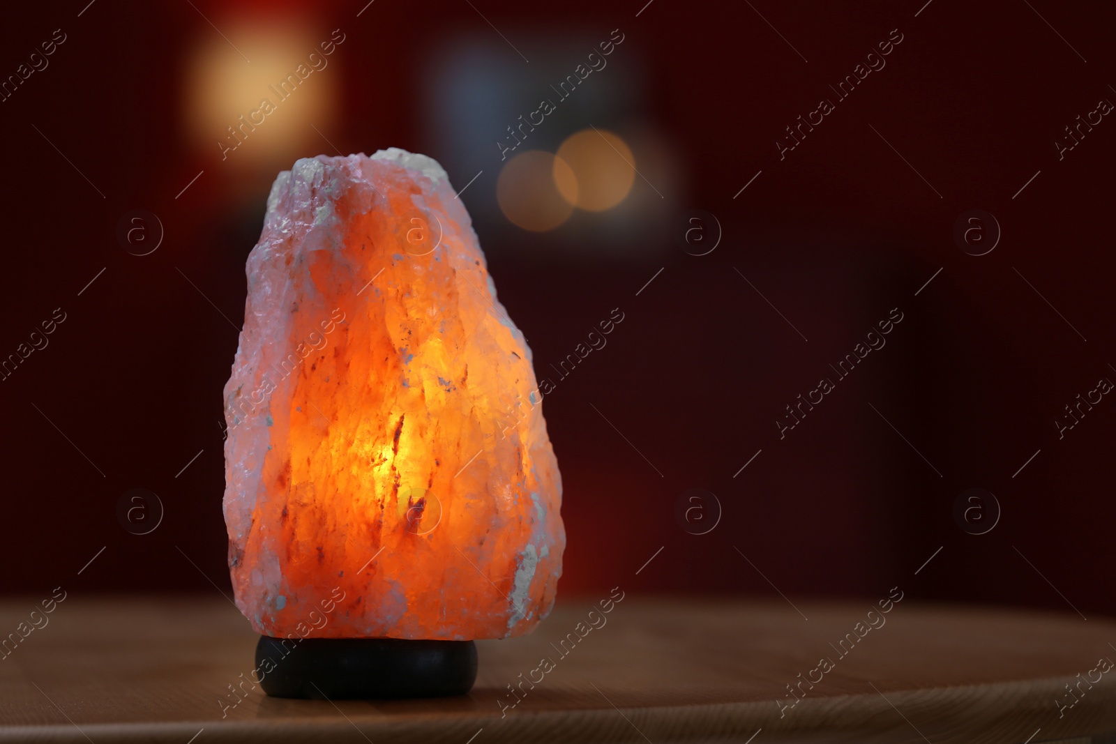 Photo of Himalayan salt lamp on table indoors, space for text