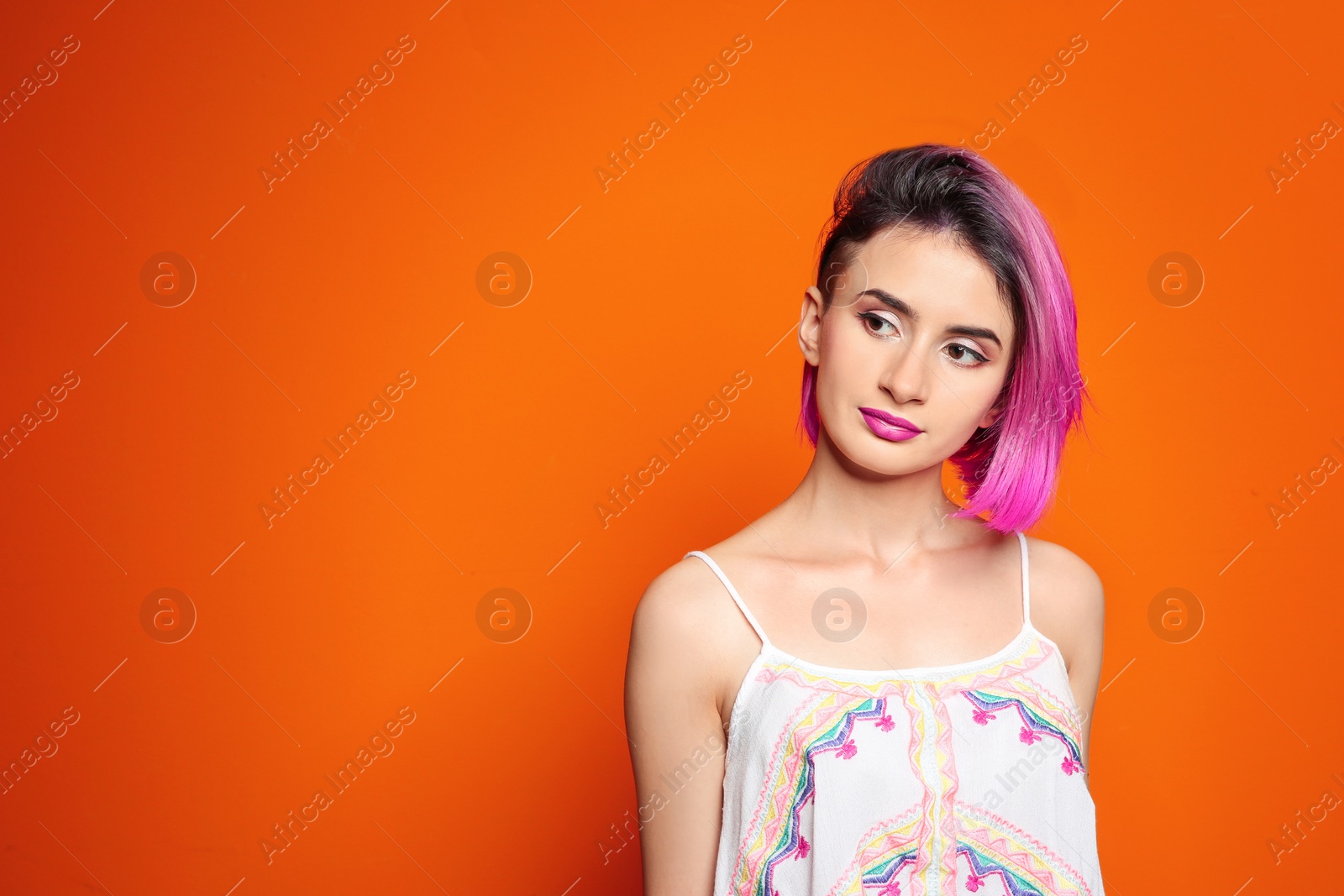 Photo of Young woman with trendy hairstyle against color background