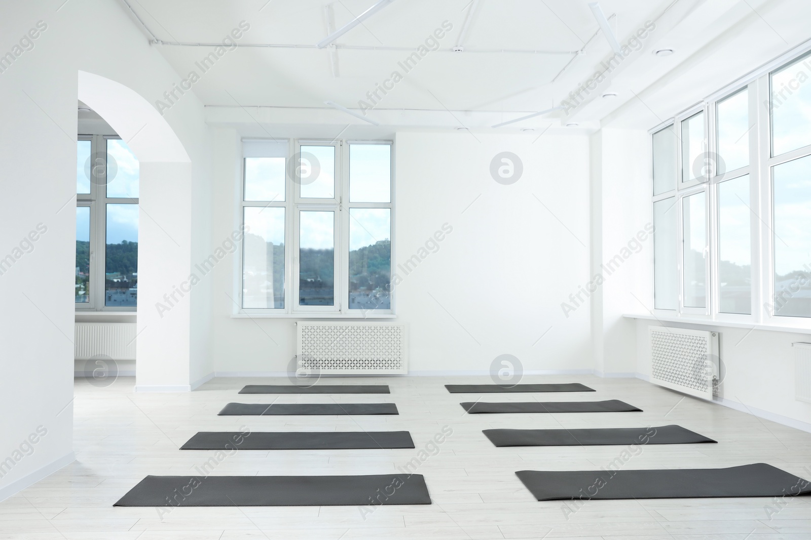 Photo of Spacious yoga studio with exercise mats and big windows