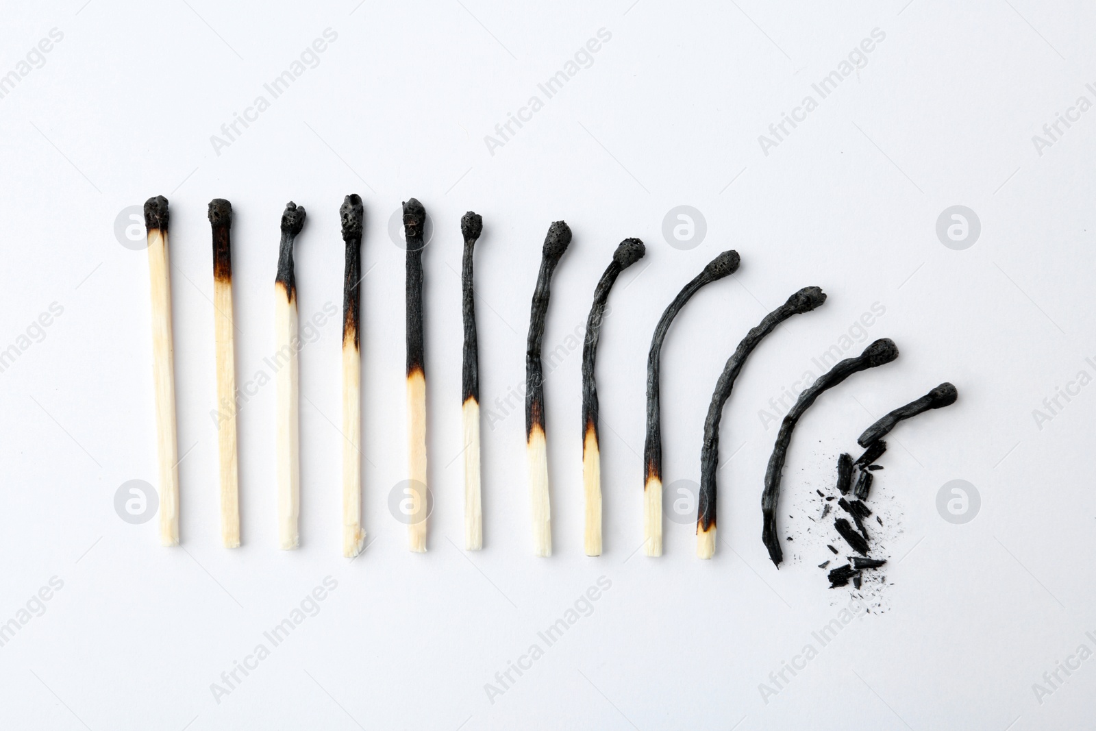 Photo of Row of burnt matches on white background, top view. Human life phases concept