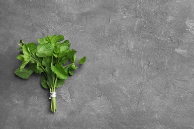 Bunch of fresh mint on grey background, top view. Space for text