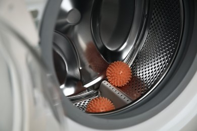 Dryer balls in washing machine drum, closeup