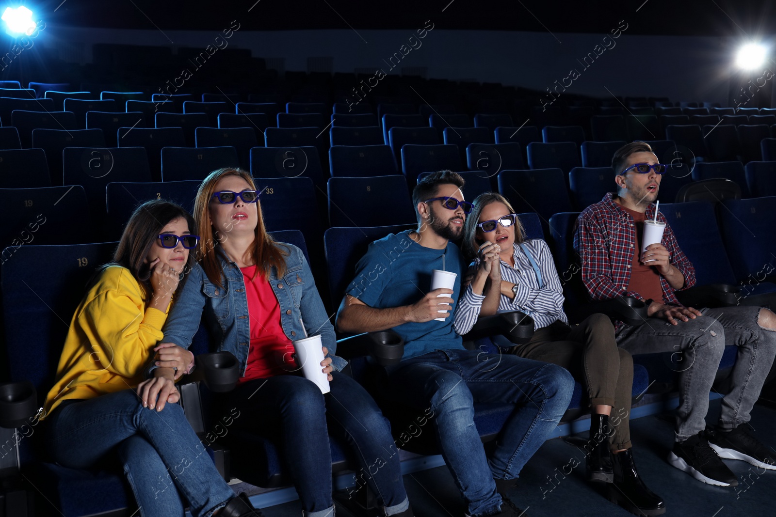 Photo of Young people watching movie in cinema theatre