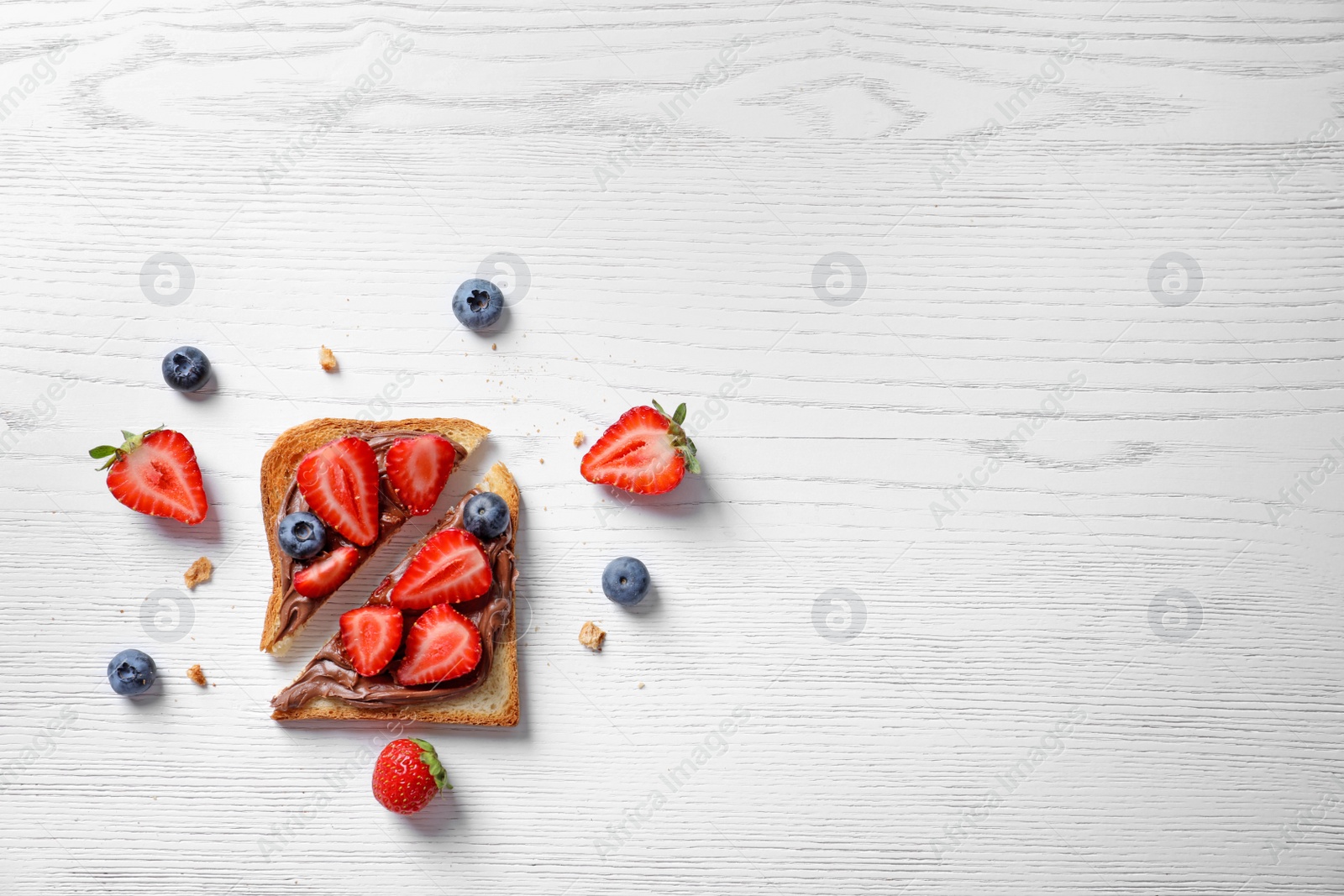 Photo of Flat lay composition with toast bread, strawberry and blueberry on light background