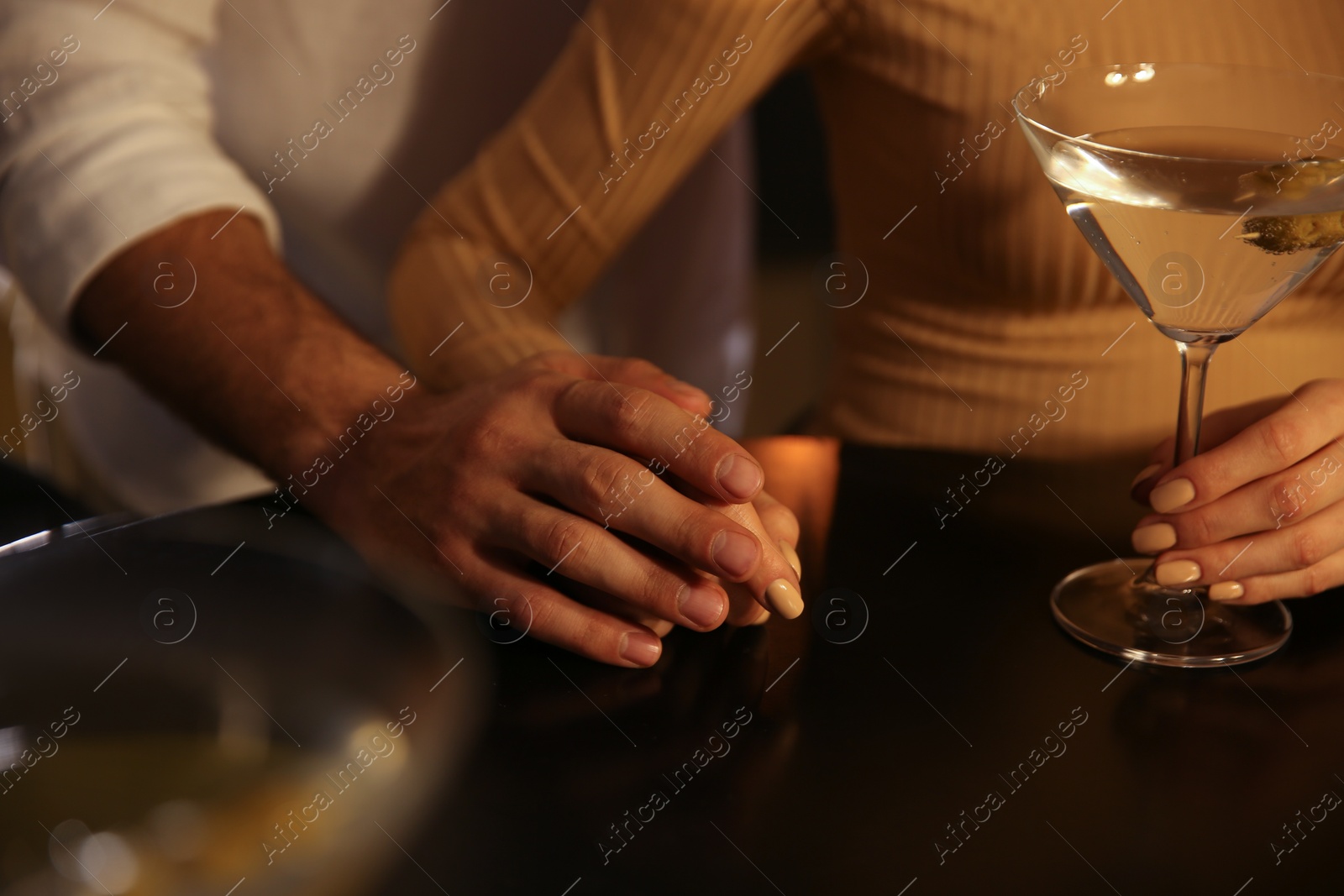 Photo of Man and woman flirting with each other in bar, closeup