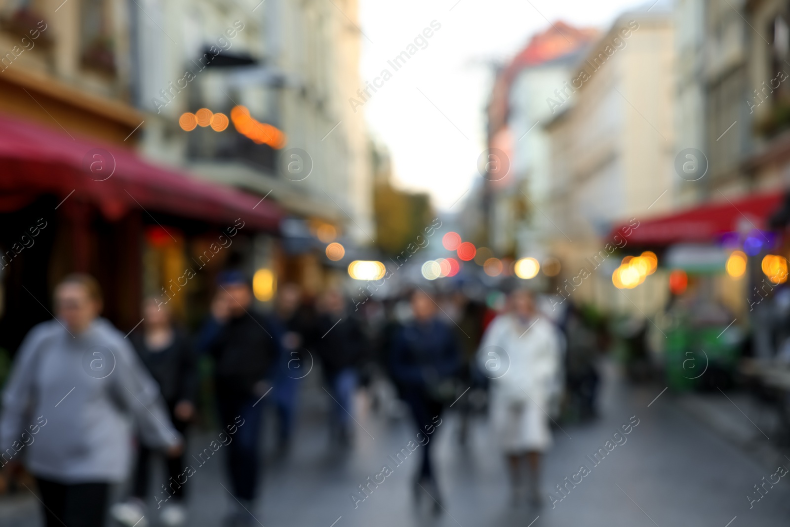 Photo of Blurred view of people walking on city street