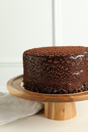 Photo of Delicious chocolate truffle cake on light wooden table