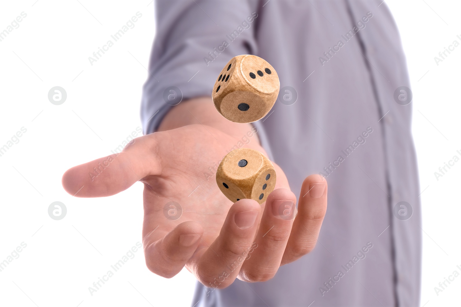 Image of Man throwing wooden dice on white background, closeup