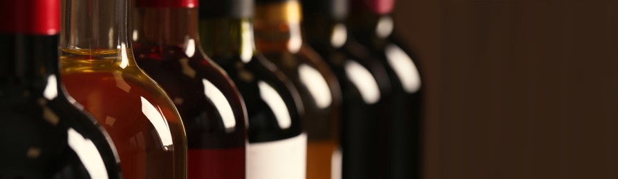 Image of Bottles of different wines, closeup. Banner design