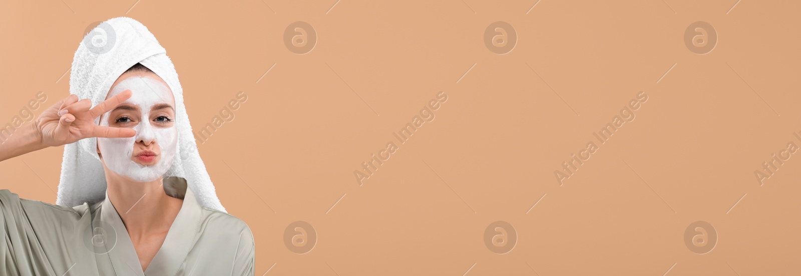 Image of Spa treatment. Woman with face mask on pale orange background. Banner design with space for text