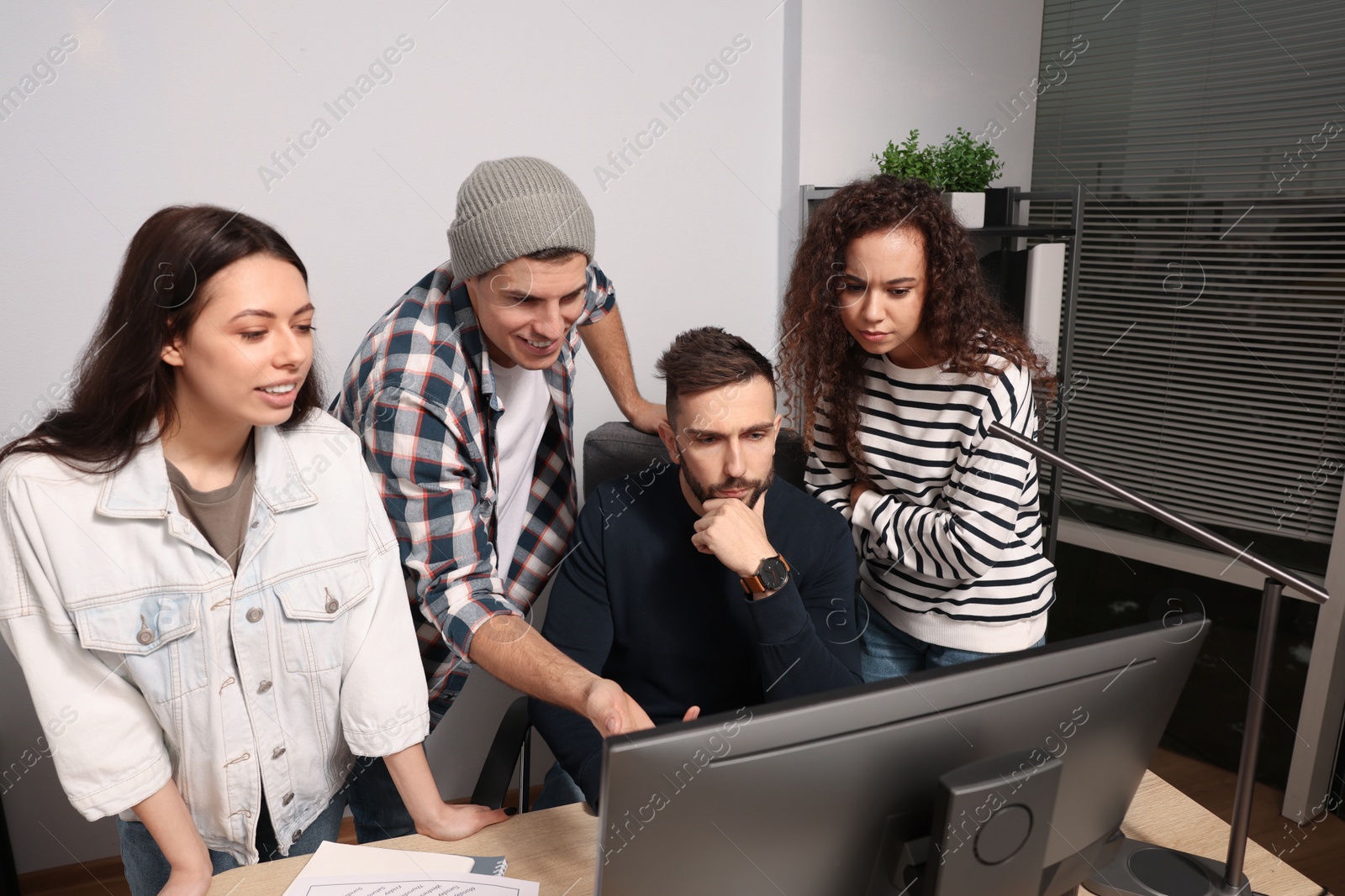 Photo of Team of employees working together in office. Startup project